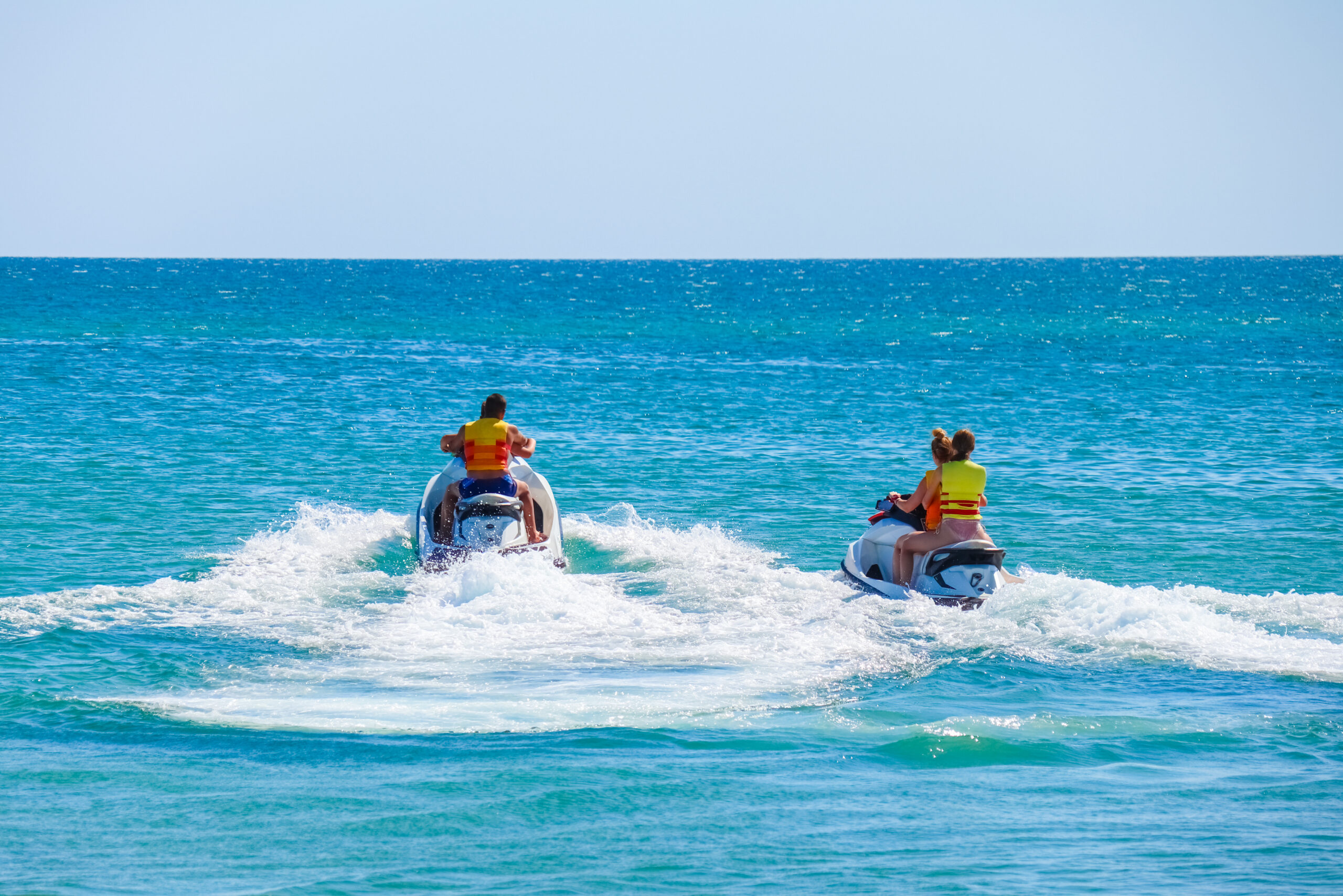 a man rides a jet ski in the open sea excursion médina palmeraie Oasis Fitness Tozeur