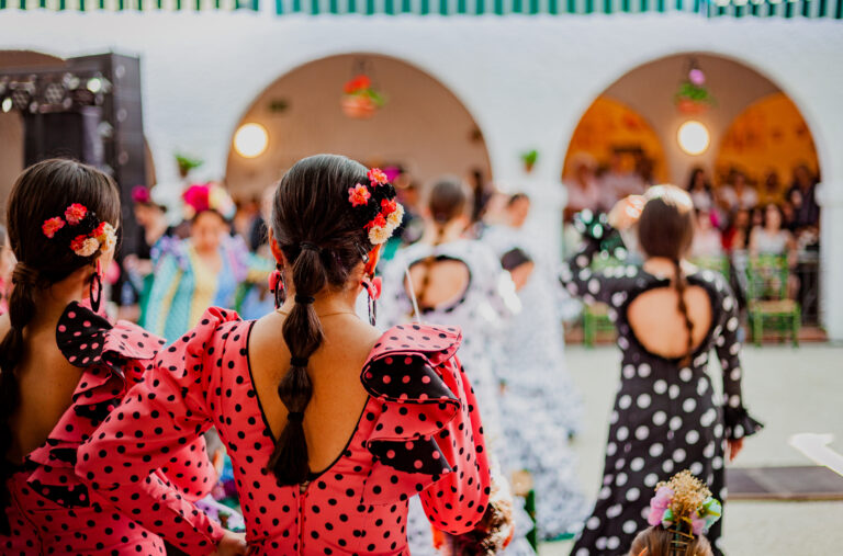 spanish woman dressed as sevillanas at a traditional festival in Rota, Spain